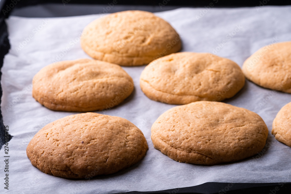 Homemade shortbread cookies on parchment paper in baking tray Homemade shortbread cookies on parchment paper in baking tray