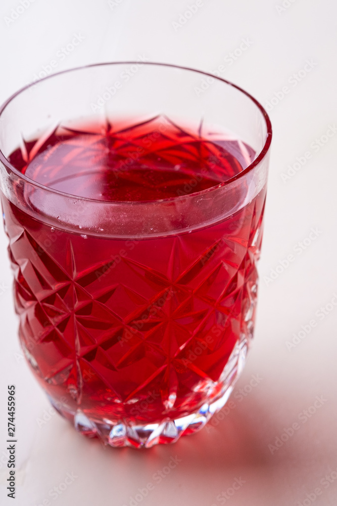 Stewed fruit red compote drink in textured transparent glass Stewed fruit red compote drink in textured transparent glass