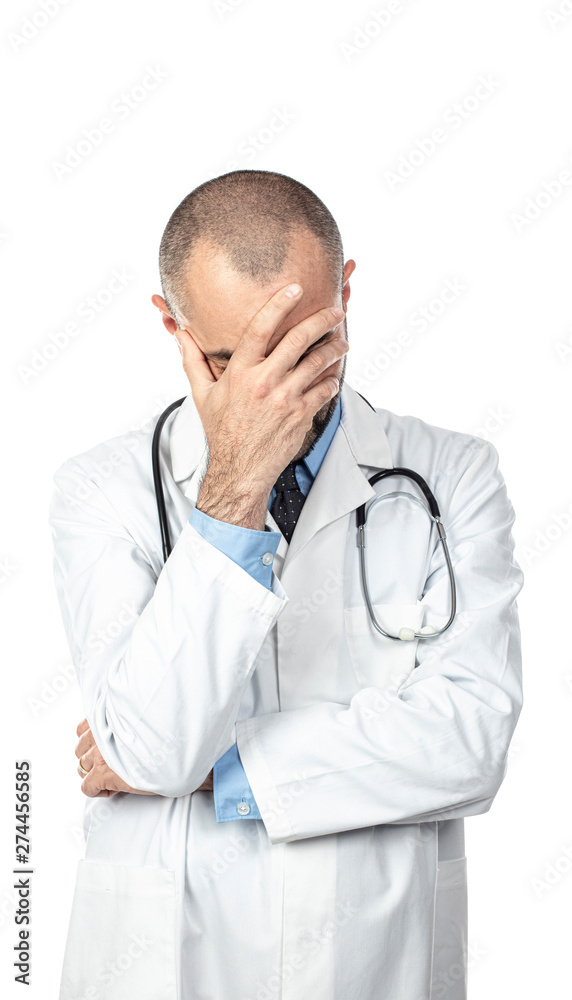 desperate doctor holds his head up with one hand. Concept of stress and failure at work. desperate doctor holds his head up with one hand. Concept of stress and failure at work.