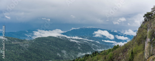 Foggy panorama of the morning plateau of the LagoNaki Republic of Adygea with low clouds above the mountain peaks