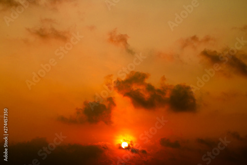 Natural light sunset of the sun with dramatic blue and orange sky from window on the wing of plane. Copy space for add text or art work designs. © NaPUN