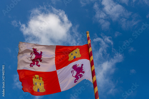 Flag of the community of Castilla y Leon, waving on a mast with the colors of Spain. The provinces of Burgos, Valladolid, Leon, Salamanca, Palencia, Avila, Segovia, Zamora, Soria belong to this commun