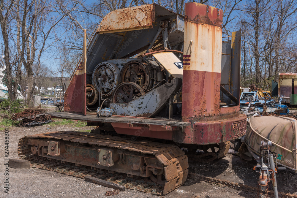 Old crane in scrap yard with engine and mechanicals visible