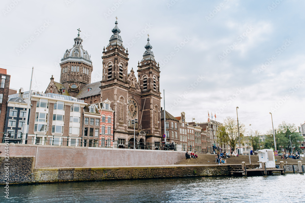 Amsterdam, Netherlands September 5, 2017: Nice and huge St. Nicolas church in Amsterdam city center near the main railway station on the canal's embankment