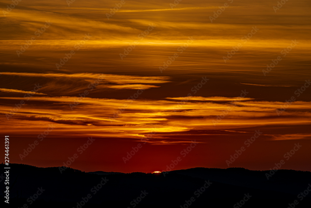 Red and orange sunset sky near Ceske Budejovice city in spring evening