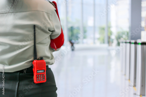 Security officers are carrying radio communications during their duties.The security guard carries a radio in the building at Bangkok ,Thailand.  photo