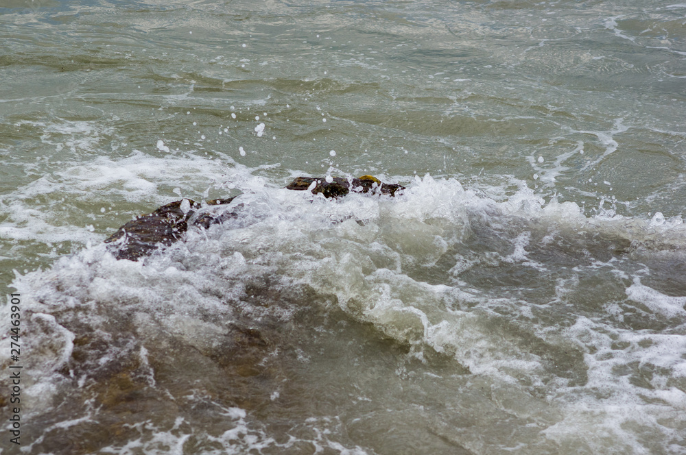 pebble stones on the sea beach, the rolling waves of the sea with foam pebble stones on the sea beach, the rolling waves of the sea with foam
