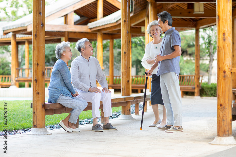 Senior friends talking in pavilion Senior friends talking in pavilion