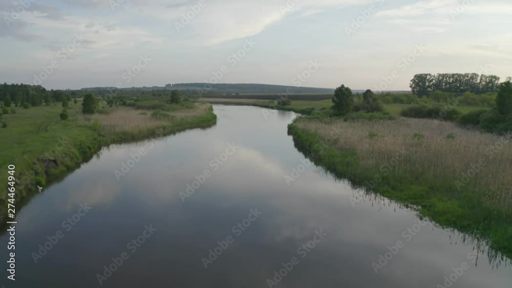 flight over the river, the river smooth surface, beautifully around, a lot of greenery and grass on the banks, beautiful view flight over the river, the river smooth surface, beautifully around, a lot of greenery and grass on the banks, beautiful view