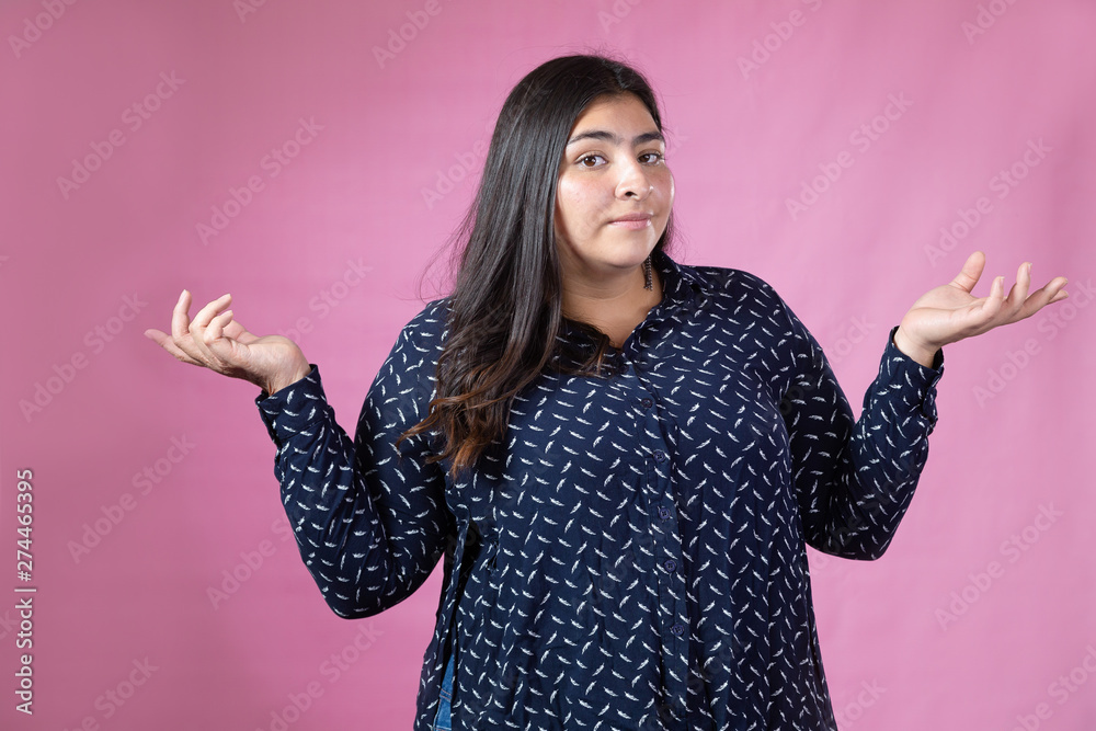 Hispanic woman making question gesture with confused face Hispanic woman making question gesture with confused face
