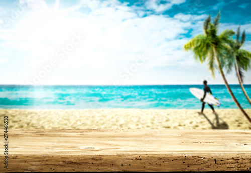 Desk of free space and summer blurred background of beach with sea 