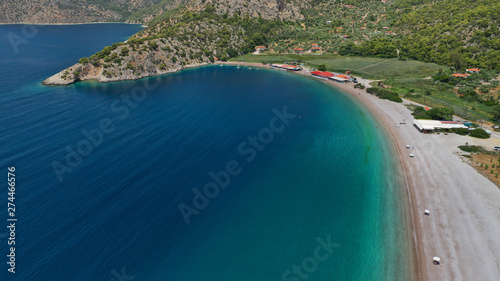Aerial photo of tropical exotic island bay with beautiful emerald sea and deep blue cloudy sky