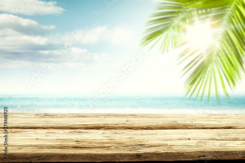 Desk of free space and summer blurred background of beach with sea 