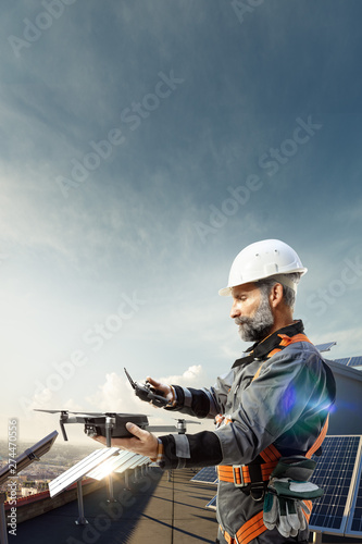 Happy engineer using drone for cheking solar station. in roof