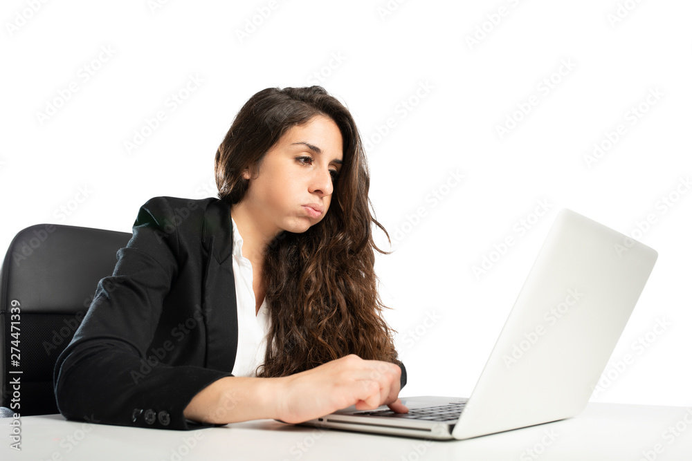 Bored woman snorts in the office while working on the laptop Bored woman snorts in the office while working on the laptop