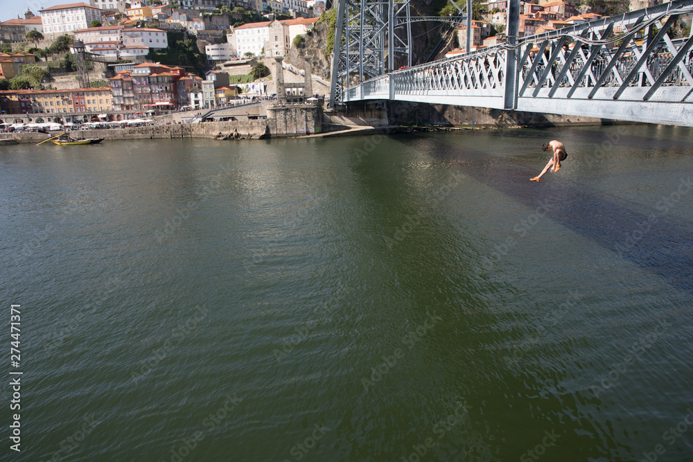 Boy jumping off bridge Poprto Lisbon