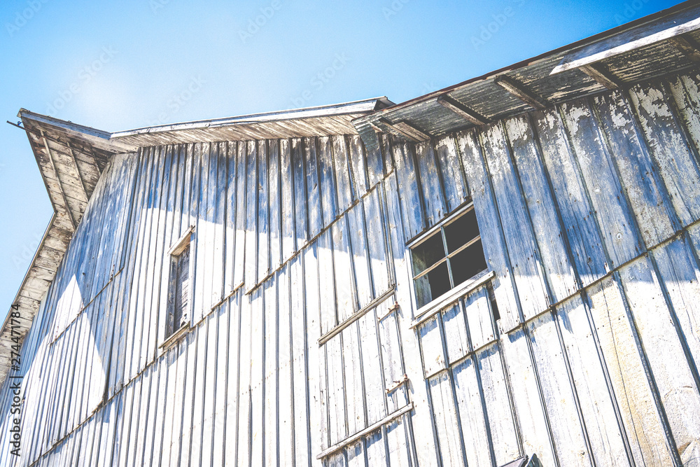 Fototapeta premium The Old Barn against a Blue Sky