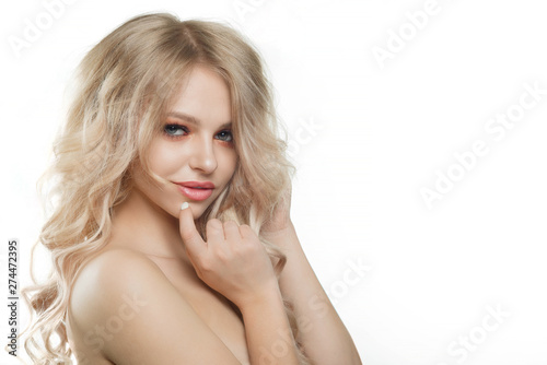 Stylish beautiful girl with flowing hair looking at camera with joyful happy facial expression.