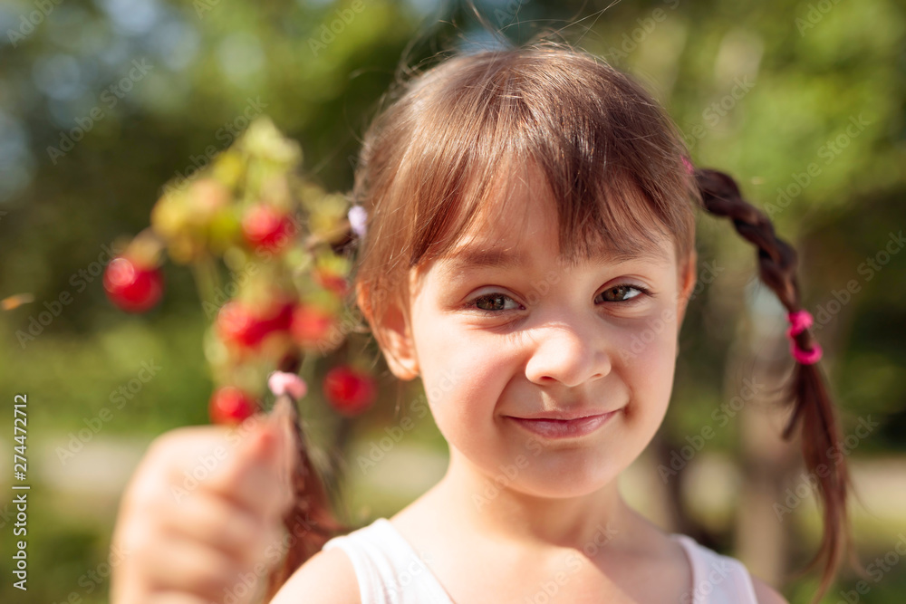 Fresh wild strawberries closeup. Little girl holding strawberry in hand. Fresh wild strawberries closeup. Little girl holding strawberry in hand.