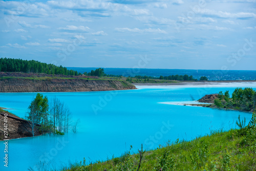 Alkaline solution. Ash dump dumping waste into the water. Ecological catastrophy. Turquoise dead water is like an oasis. The result of the waste plant.