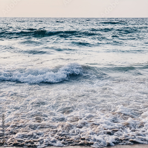 Beautiful tropical beach view with white sand  blue sea with waves and clear sky on Phuket  Thailand. Minimal composition with neutral colors. Summer and travel concept.