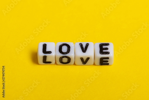 Love text on yellow background.