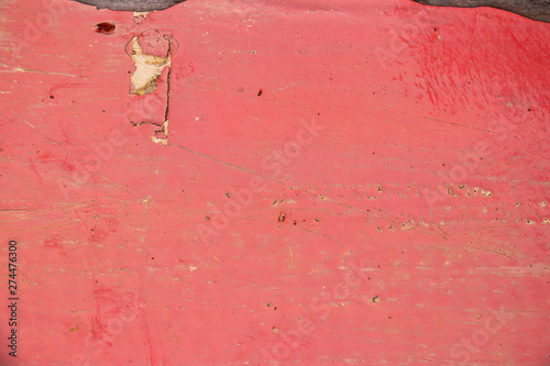 Pink painted worn metal surface