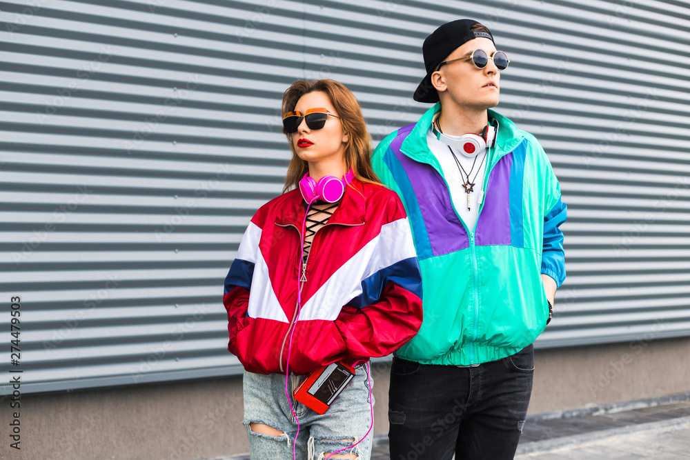 Back in time 90s 80s. Stylish young man in a retro jacket and a girl in