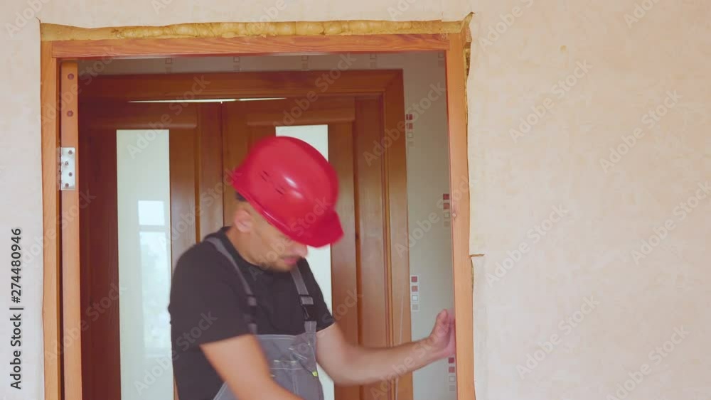Upset, unhappy man working with laptop and blueprints at his new home Upset, unhappy man working with laptop and blueprints at his new home