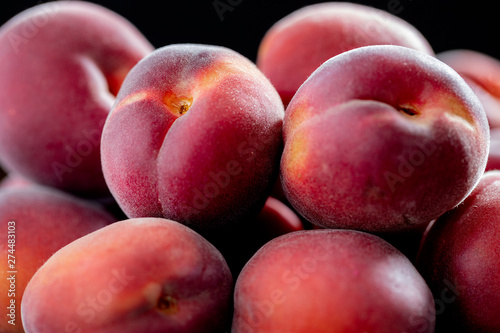 Dark velvety apricots close up. Black background.