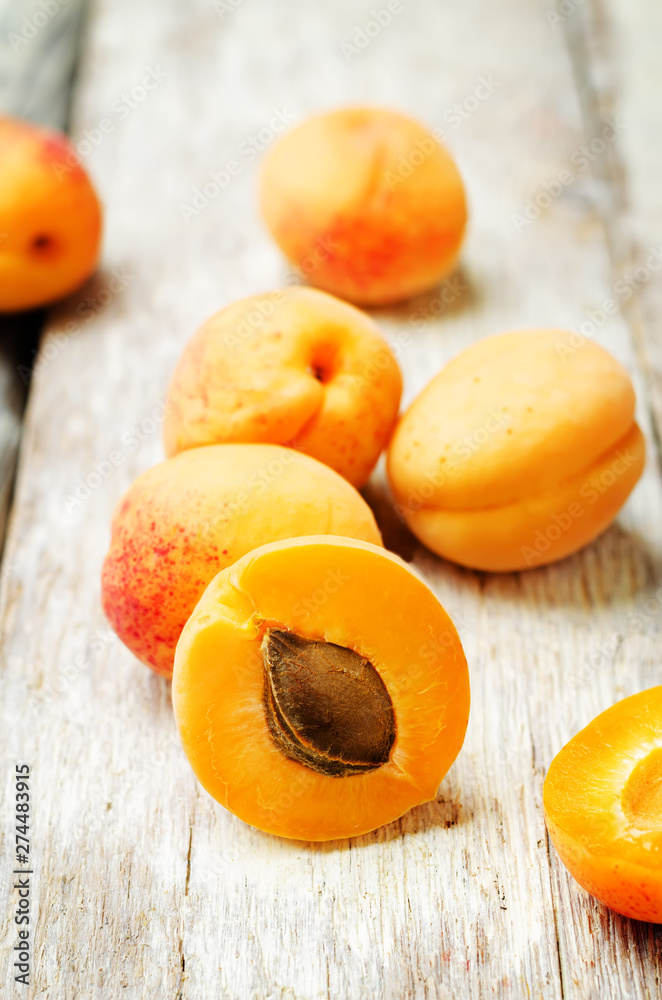 apricots with slices on a wooden background