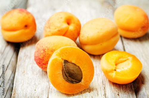 apricots with slices on a wooden background