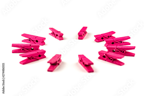 Pink wooden clothespins isolated on white background arranged in a circle