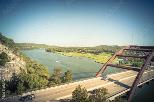 Filtered image Pennybacker Bridge over Colorado river and Hill Country landscape in Austin photo