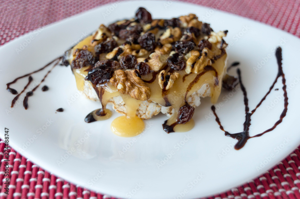 Rice biscuit with honey, nuts and raisins without seeds bathed in light chocolate threads. Rice biscuit with honey, nuts and raisins without seeds bathed in light chocolate threads.