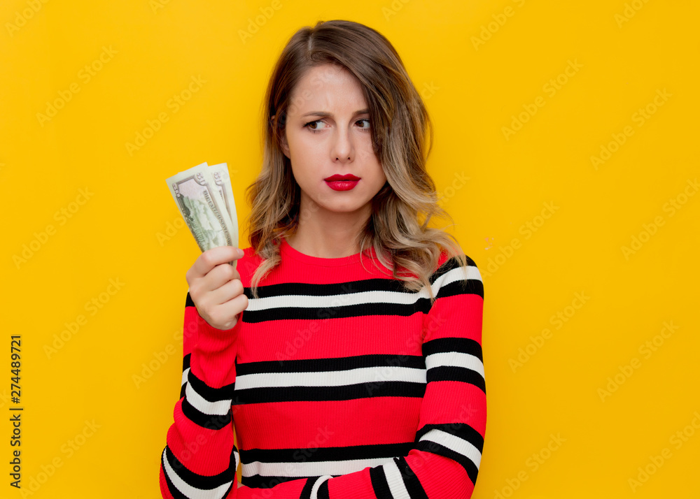 Young woman in red striped sweater with cash Young woman in red striped sweater with cash