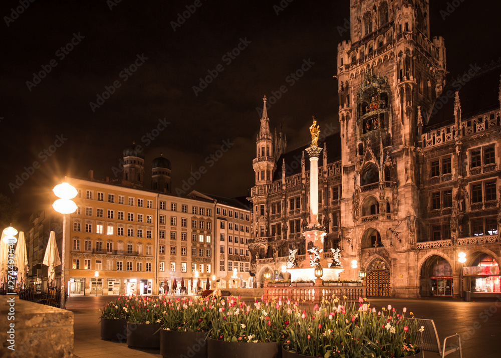 Munich Germany, New Town Hall , Rathaus at the Marienplatz seen at night with spring tulips in bloom