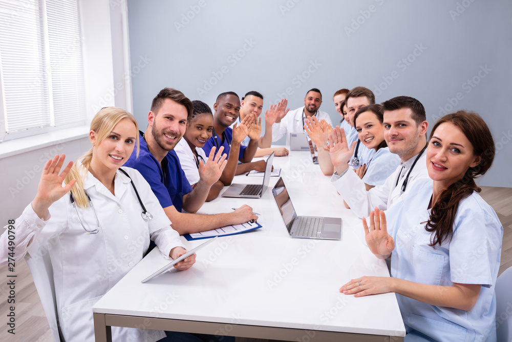 Fototapeta premium Doctors Waving Their Hands In Conference Room