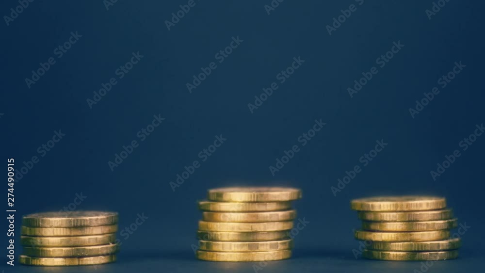 Golden Coins Stack on Dark Blue Back Stop Motion Video Golden Coins Stack on Dark Blue Back Stop Motion Video