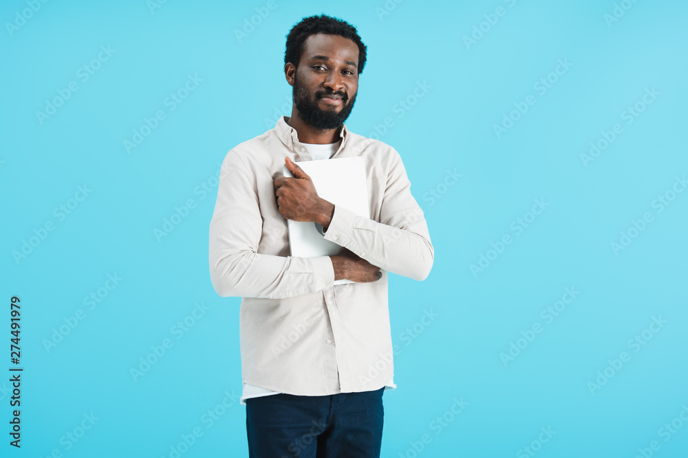 happy african american man holding laptop isolated on blue happy african american man holding laptop isolated on blue