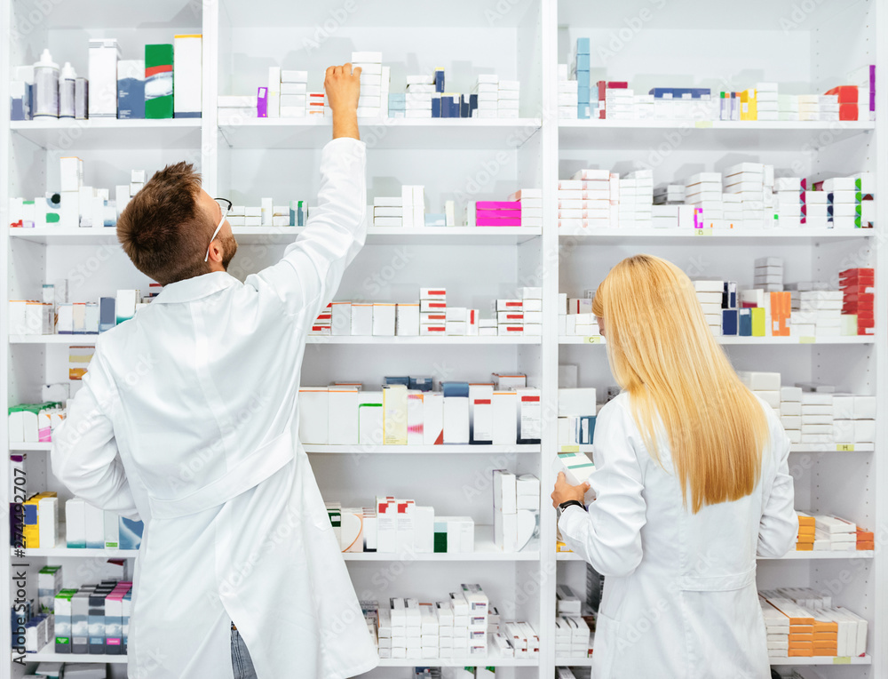 Two pharmacists working in drugstore