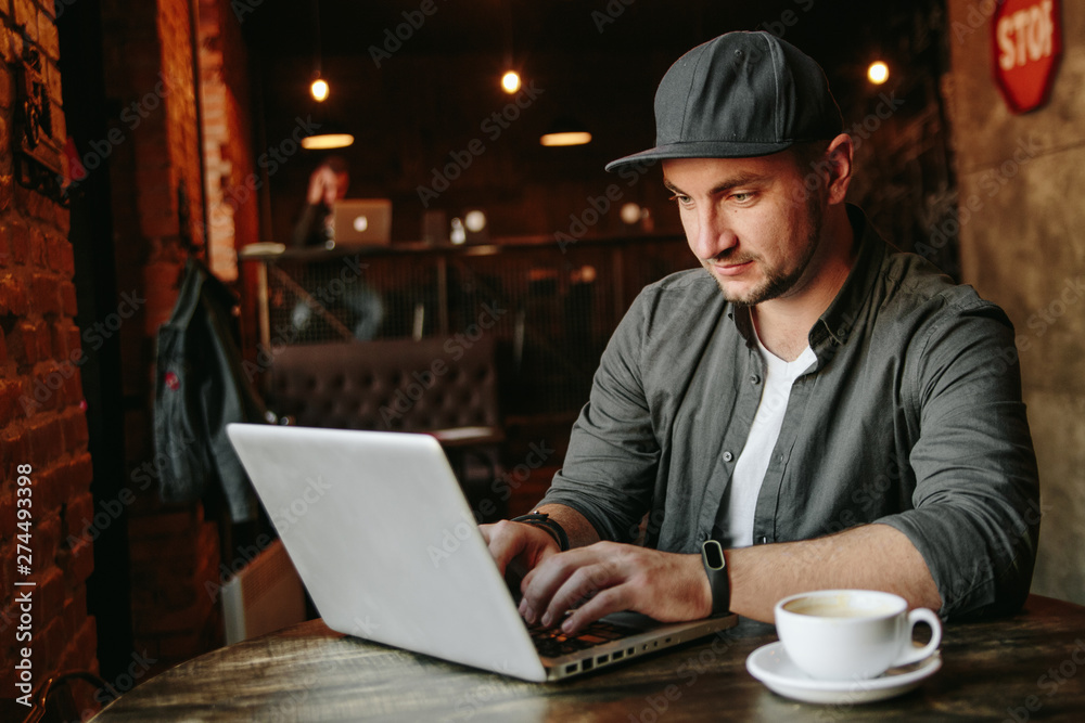 young man working in cafe and drink black coffee young man working in cafe and drink black coffee