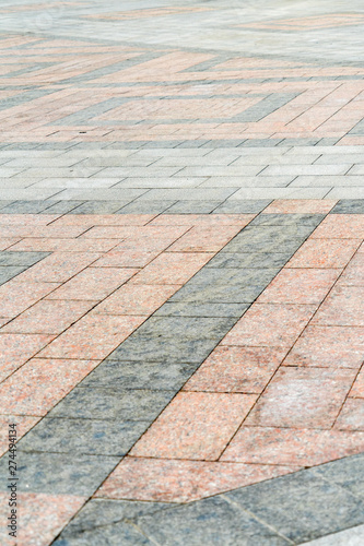 Natural stone laid on the pavement with a pattern.