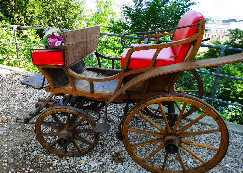 Old red vintage city carriage  with bouquet of flowers