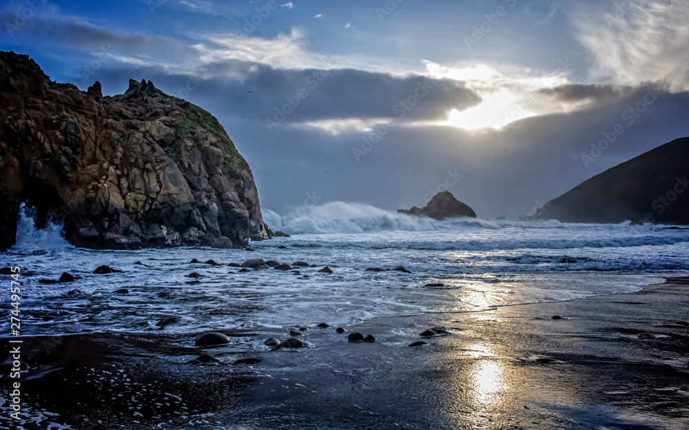 Sunset with Fog Surf and Rocks on California Beach