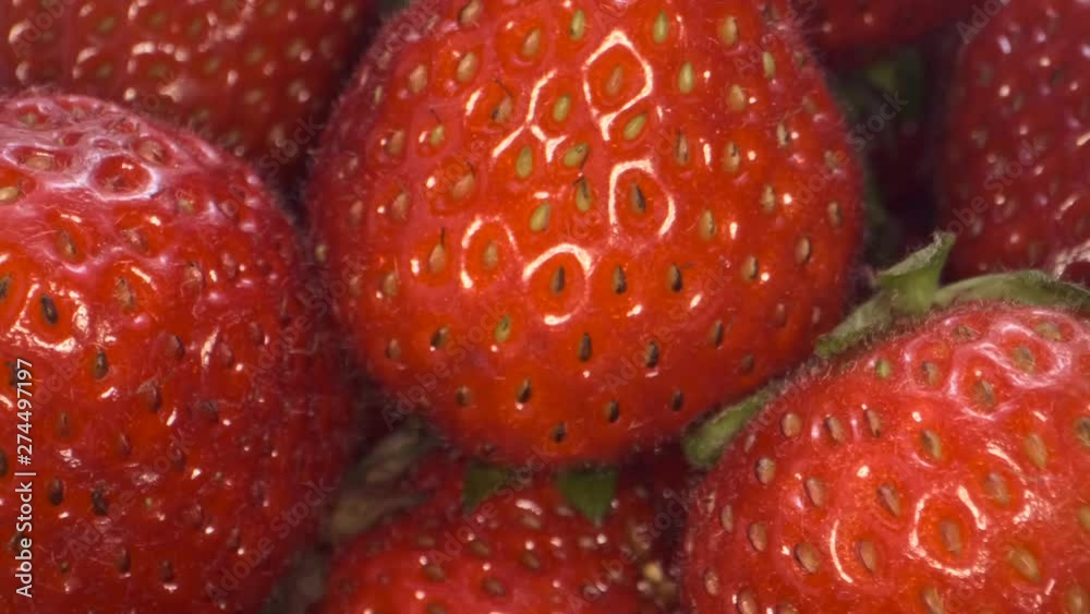 Extreme close up of ripe strawberries. Rotation 360 degrees. 4K - 50fps Extreme close up of ripe strawberries. Rotation 360 degrees. 4K - 50fps
