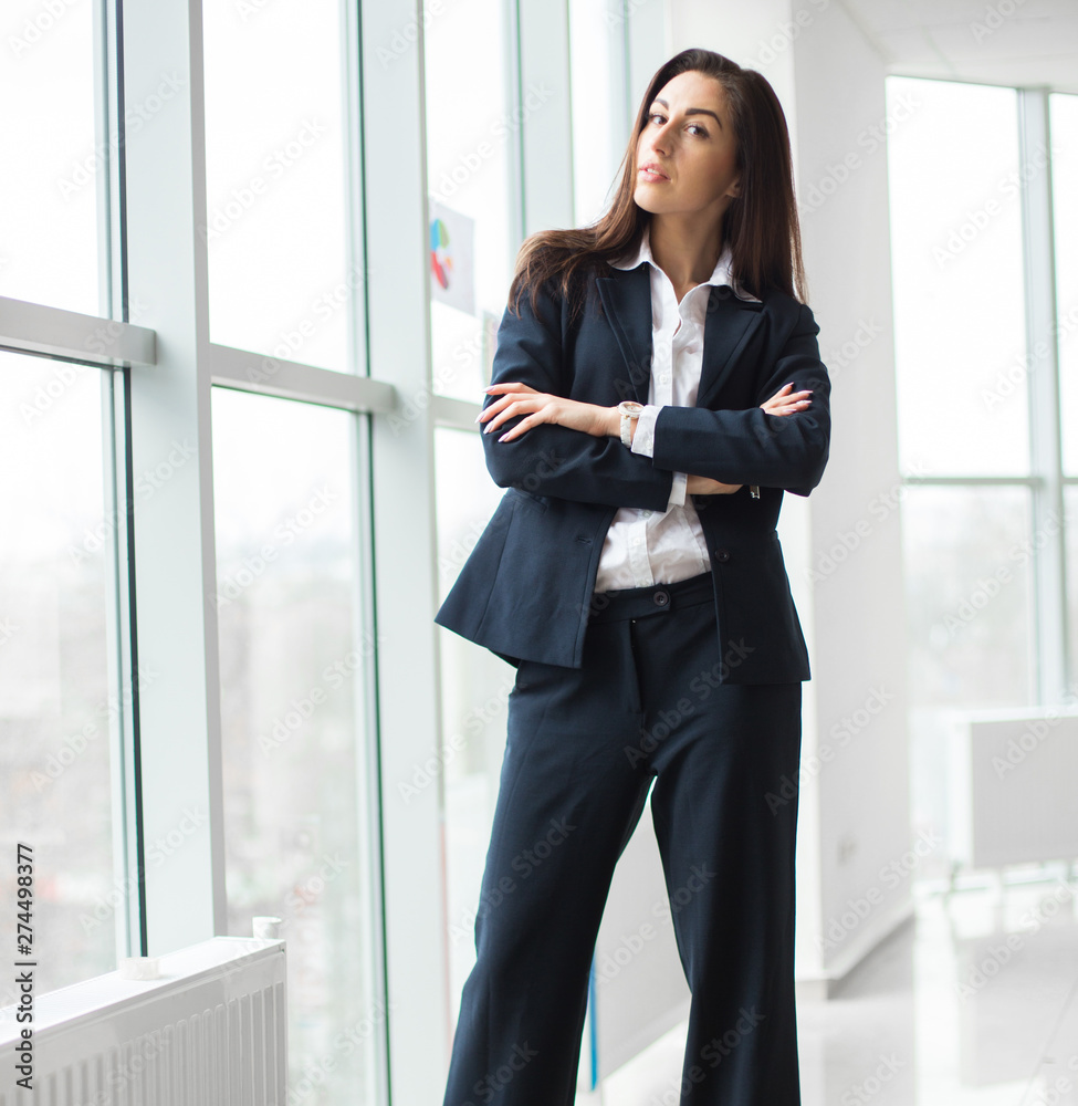 Young businesswoman sitting at workplace and reading paper in office Young businesswoman sitting at workplace and reading paper in office