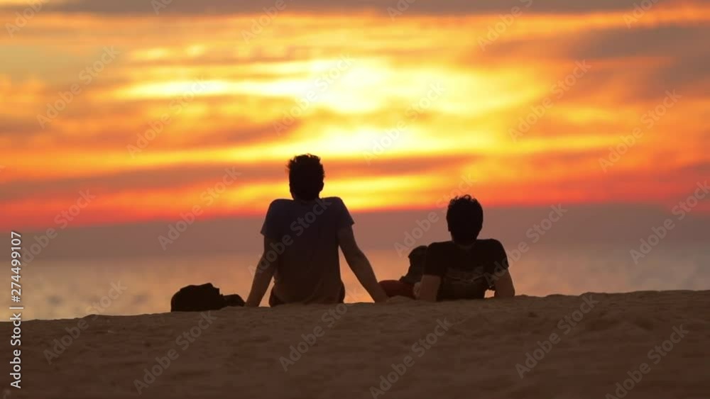 VENICE BEACH, SANTA MONICA, LOS ANGELES, California. Silhouettes of people watching sunset on the beach. Golden hour at Venice Beach. VENICE BEACH, SANTA MONICA, LOS ANGELES, California. Silhouettes of people watching sunset on the beach. Golden hour at Venice Beach.
