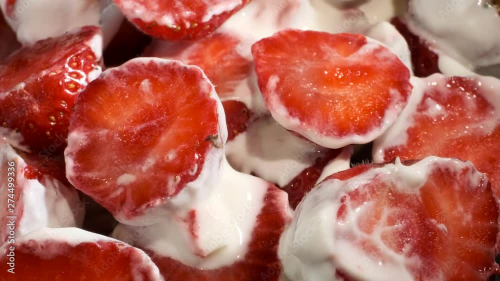Pieces of fresh juice strawberries covered with thick layer of cream. Camera rotation 360 degrees, top view, close-up. 4K - 50fps Pieces of fresh juice strawberries covered with thick layer of cream. Camera rotation 360 degrees, top view, close-up. 4K - 50fps