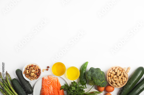 Ketogenic, keto diet, including vegetables, meat and fish, nuts and oil on white background with copy space